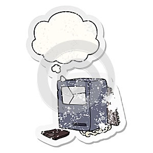 A creative cartoon broken old computer and thought bubble as a distressed worn sticker
