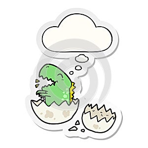 A creative cartoon dinosaur hatching and thought bubble as a printed sticker