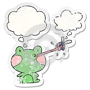 A creative cartoon frog catching fly and thought bubble as a distressed worn sticker