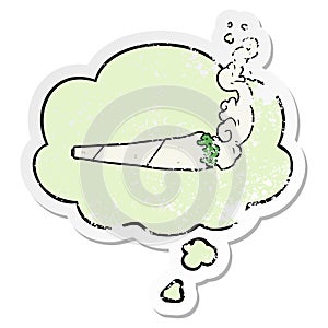 A creative cartoon marijuana joint and thought bubble as a distressed worn sticker photo