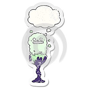 A creative cartoon spooky halloween potion cup and thought bubble as a distressed worn sticker