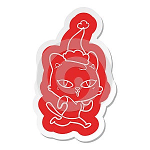 A creative cartoon  sticker of a cat out for a run wearing santa hat