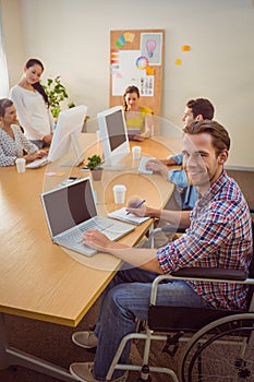 Creative casual businessman in wheelchair