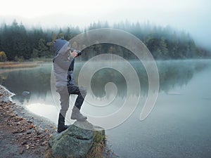 Creative child, kid photographer a little boy with a camera taking landscape pictures near la lake