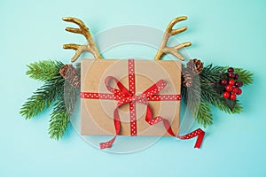Creative Christmas background with gift box and reindeer horns