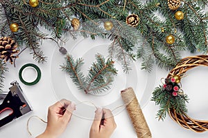 Creative christmas diy. Woman making handmade xmas wreath. Home leisure, tools, trinkets and details for holiday