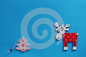 Creative Christmas or New Year composition. View from above. The background is blue with wooden toys and copy space. Greeting card