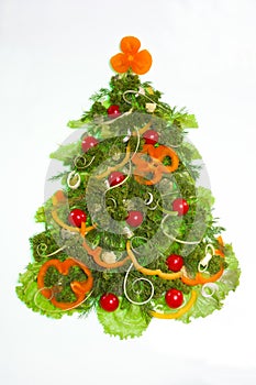 Creative christmas tree made of vegetables isolated on white