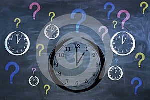 Creative clock and question marks sketch on chalkboard wall background.