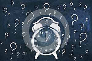 Creative clock and question marks sketch on chalkboard wall text