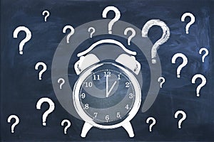 Creative clock and question marks sketch on chalkboard wall wallpaper. Time management concept