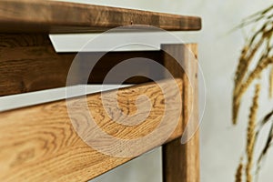 Creative close up composition of elegant wooden dining table. Beautiful home decorations and accessories. Modern home interior.