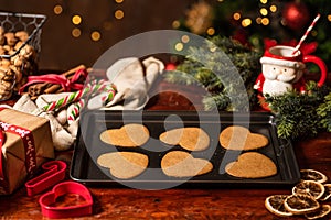 Creative cockies and a cup with Santa cover on a table with blur illuminated lights