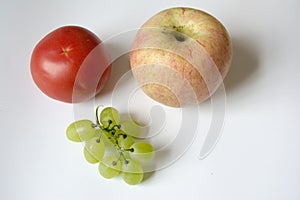 Creative combination photo of tomato, apple and grape