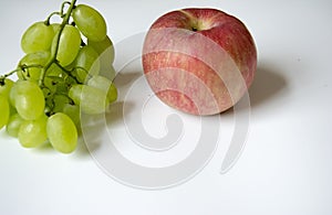 Creative combination of red apple and green grape