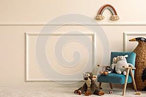 Creative composition of cozy children room interior with copy space, blue velvet armchair, animal plush toys, wicker basket, beige