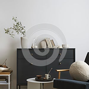 Creative composition of living room interior with navy blue commode, velvet armchair, round pillow, coffee table, decoration and