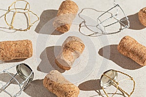 Creative composition made of champagne corks on beige sunlit background with shadow. Bottle caps from sparkling wine and metal