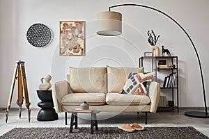 Creative composition of modern living room interior with mock up poster frame, beige sofa, side table.