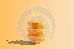 Creative composition with orange juice and straw on bright background. Minimal fruit concept