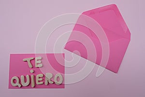 Te quiero, spanish I love you composed with handmade wooden letters over pink card photo