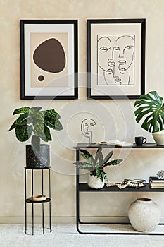 Creative composition of stylish modern living room interior with two mock up poster frames, black geometric commode, plants.