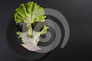 Creative concept, cubist style portrait made from lettuce  isolated on white