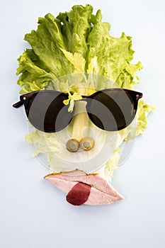 Creative concept, cubist style portrait made from lettuce  isolated on white