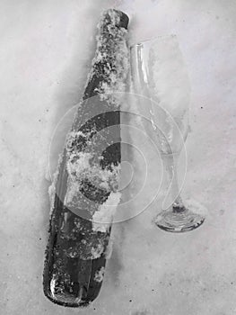 Creative concept drink made with frozen glass and bottle in snow