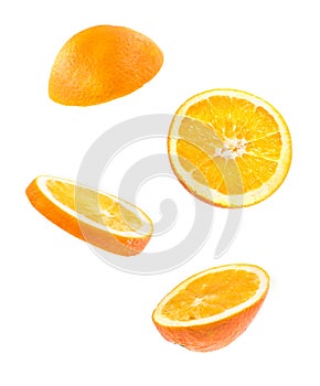 Creative concept with Flying orange. Sliced orange isolated on white background. Levity fruit floating in the air.