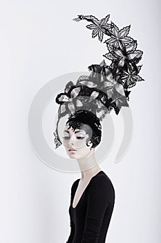 Creative Concept. Futuristic Woman in Art Fabulous Headdress