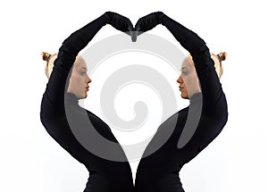 Creative concept, heart, symbol of love, fromed by two female bodies mirroring each other