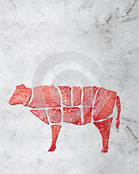 Creative concept marbled meat beef on white marbled background. Top view