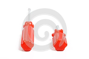 Two bright red screwdrivers on white background