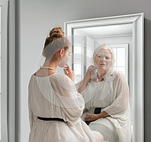 Creative conceptual collage. Young girl looking in mirror with older reflection of herself. Emotions and feelings. Look