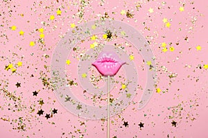 Creative confetti background with pink lips. Top view