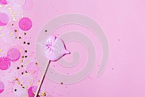 Creative confetti background with pink lips. Top view