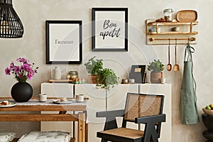 Creative and cozy kitchen interior composition with mock up poster frames, beige commode, plants, chair, family table.