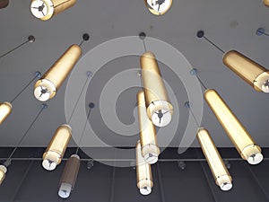 Creative cylinder ceiling lamp.Ceiling with pendant lamps, long light tube. Interior design detail. Modern industrial style