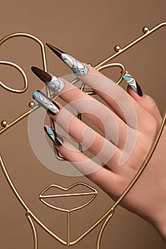 Creative design of nails on female hands. Art manicure.