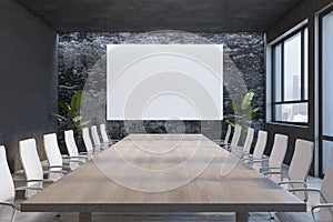 Creative designer stone meeting room interior with empty white mock up poster on wall, wooden table, chairs, decorative plants and