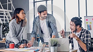 Creative designer team argument at casual meeting table and walk out from meeting in modern office.tea,m conflict concept