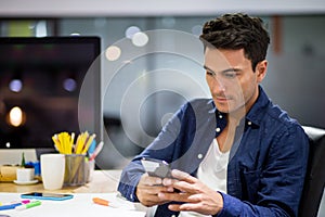 Creative designers man working with smart phone in the  modern office . Businessman using mobile phone app texting to Contact