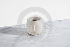 Creative diagonal isometric projection. Composition with Concrete flower pot with Buddha face. Bust, statue. Modern still life.