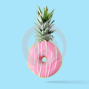 Creative disposition of donut pineapple on bright background.