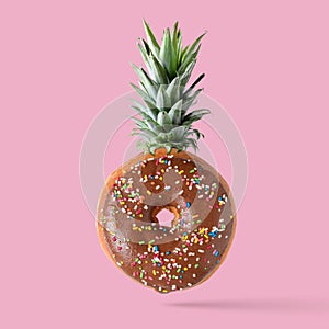 Creative disposition of donut pineapple on bright background.