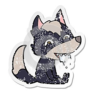 A creative distressed sticker of a cartoon hungry wolf sitting waiting