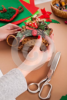 Creative diy hobby. Handmade craft christmas decoration, sleigh with toys and spruce tree branch