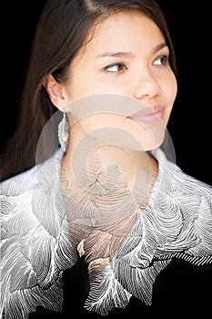 A creative double exposure portrait of an attractive woman combined with a painting of leaves. Paintography.