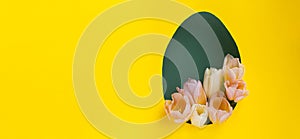 Creative Easter layout with tulip flowers on yellow and green paper background.